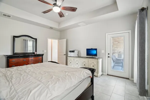 a view of a brick house with a big yard and large trees