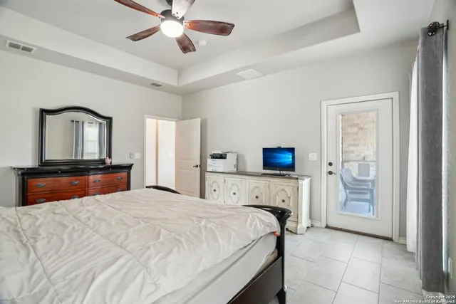 a view of a brick house with a big yard and large trees