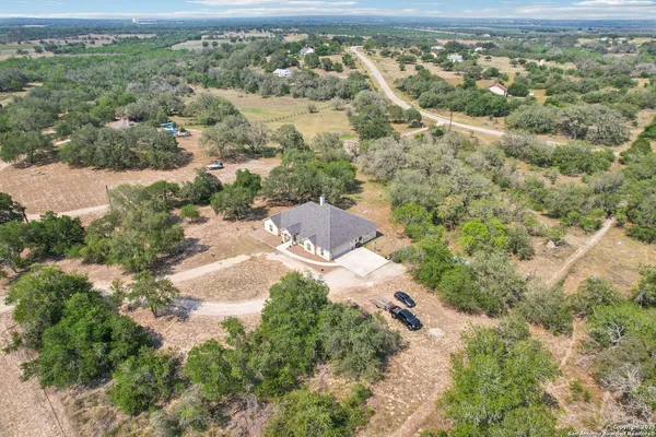 an aerial view of residential houses with outdoor space