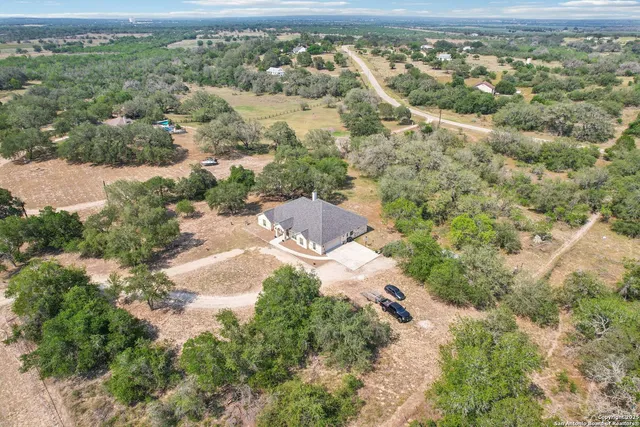 an aerial view of residential houses with outdoor space
