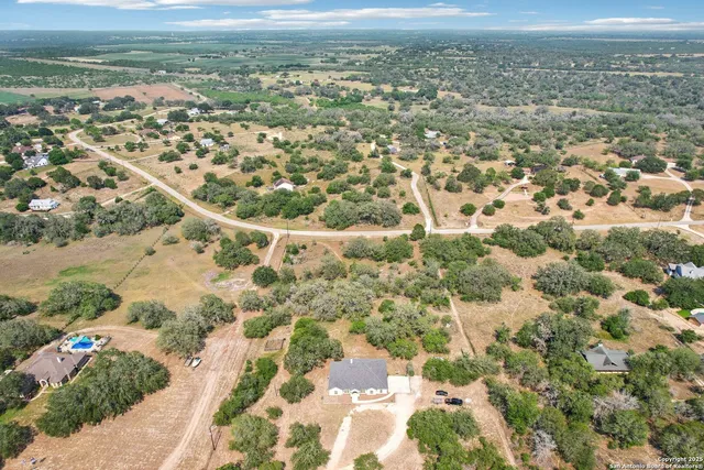 a view of a house with a swimming pool and a yard