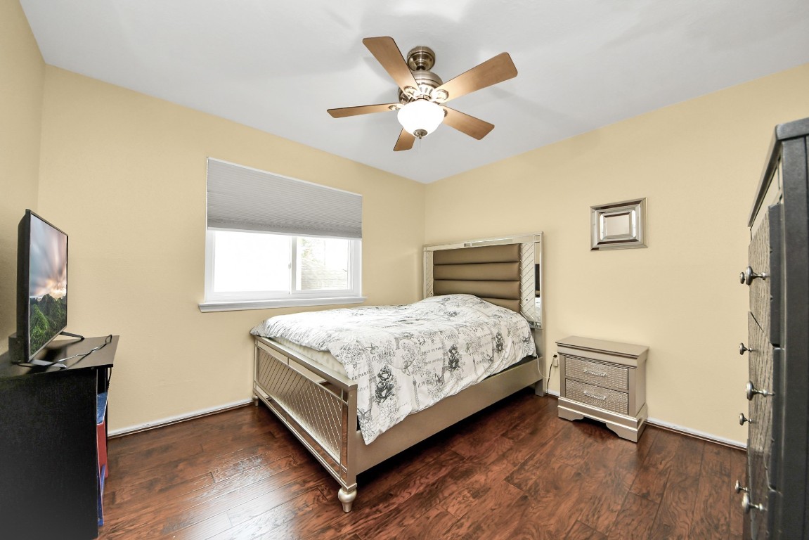 16506 Crossfield Drive Houston, TX 77095 - Photo 12 of 21 a bedroom with a bed and a flat tv screen on the dresser