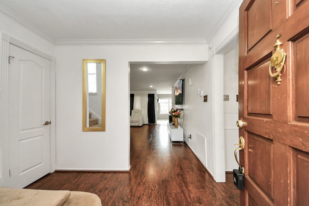 16506 Crossfield Drive Houston, TX 77095 - Photo 17 of 21 a view of a hallway with wooden floor and windows
