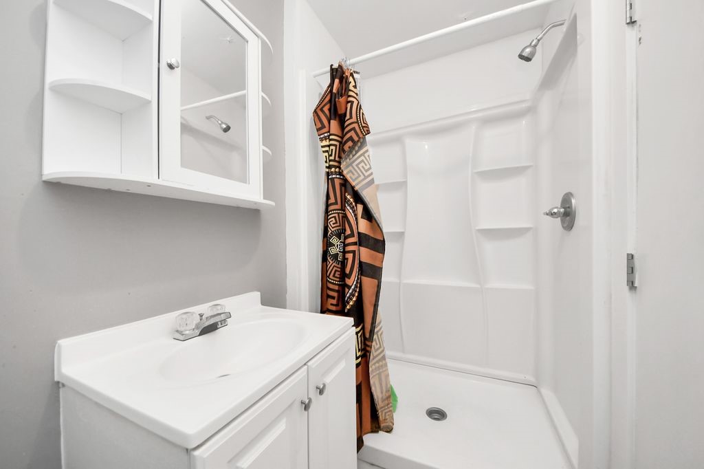 16506 Crossfield Drive Houston, TX 77095 - Photo 20 of 21 a bathroom with a sink a mirror and shower
