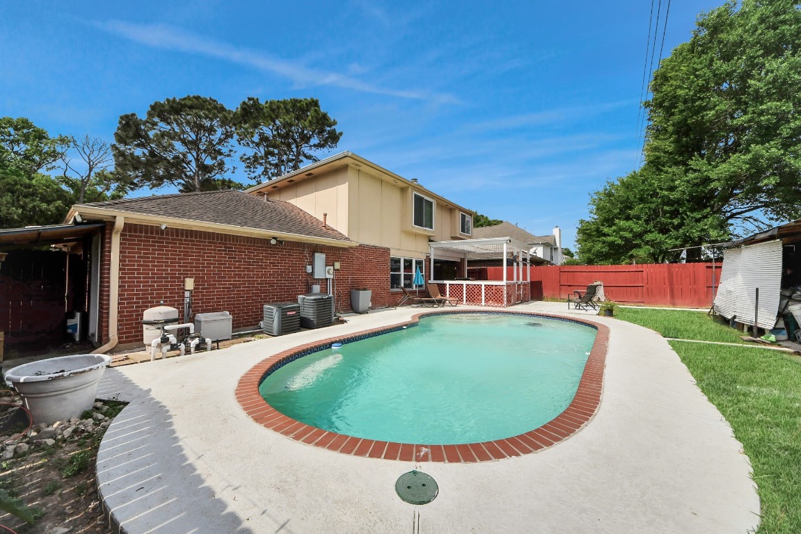 16506 Crossfield Drive Houston, TX 77095 - Photo 2 of 21 a view of a house with a swimming pool and a yard