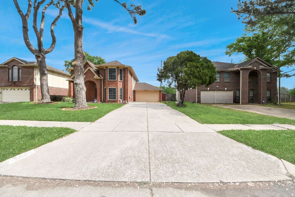 16506 Crossfield Drive Houston, TX 77095 - Photo 3 of 21 a view of a white house next to a yard with palm trees