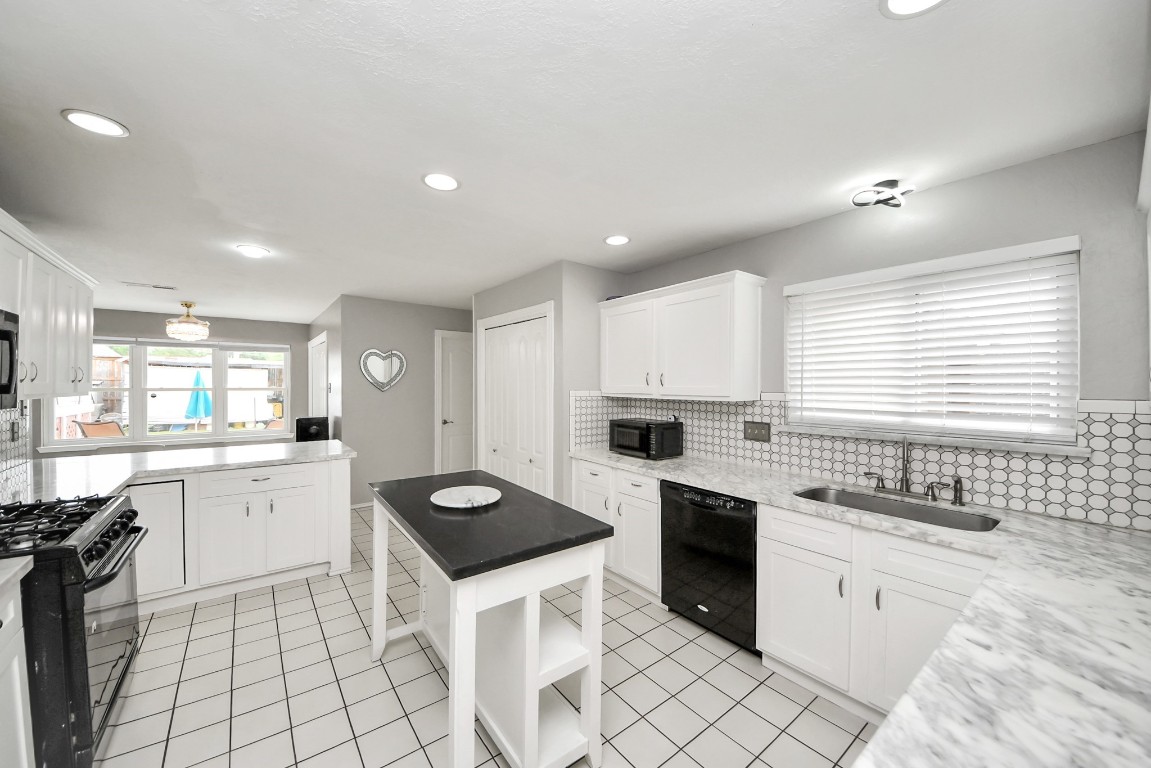 16506 Crossfield Drive Houston, TX 77095 - Photo 4 of 21 a kitchen with a sink stove top oven and cabinets