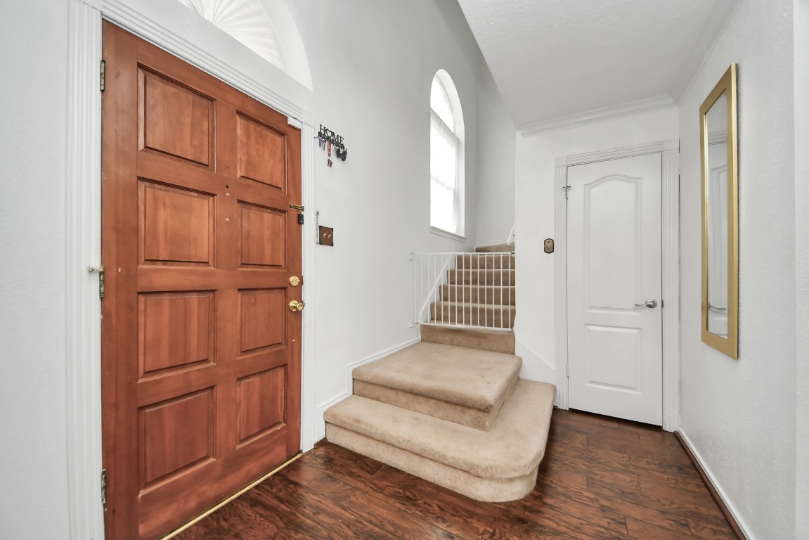 16506 Crossfield Drive Houston, TX 77095 - Photo 5 of 21 an entryway with wooden floor and cabinet