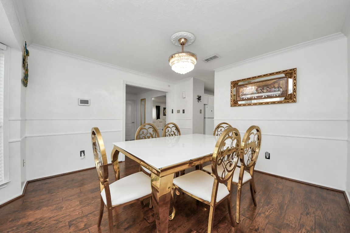 16506 Crossfield Drive Houston, TX 77095 - Photo 7 of 21 a view of a dining room and livingroom with furniture wooden floor a rug and a painting