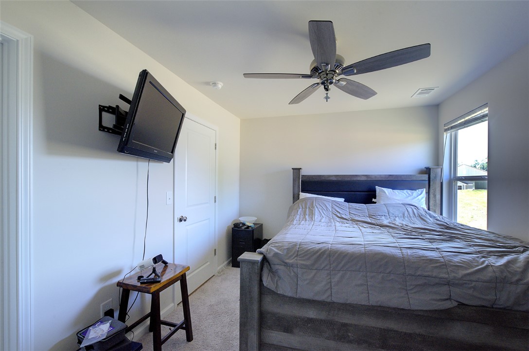 408 Chadwick Lane Walhalla, SC 29691 - Photo 24 of 44 A well-appointed sleeping sanctuary features soft carpet underfoot and a large window offering backyard views.