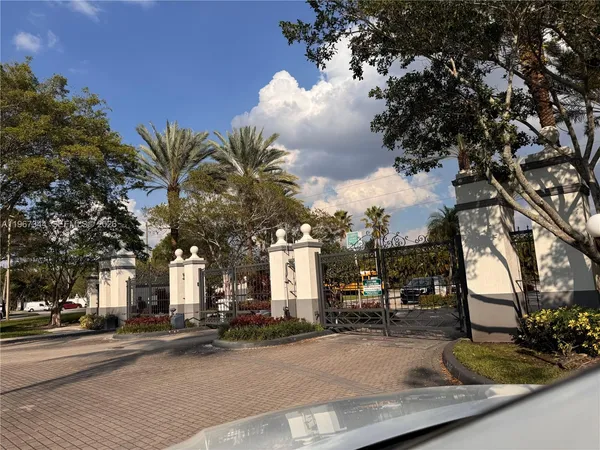 a view of a house with cars park