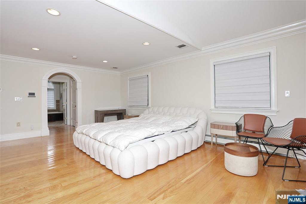65 Ross Avenue Demarest, NJ 07627 - Photo 24 of 48 a spacious bedroom with a bed and chair