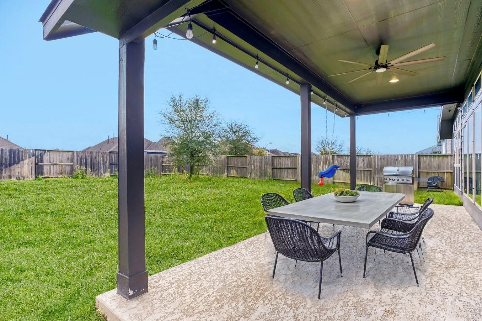 9219 Eckert Road Iowa Colony, TX 77583 - Photo 23 of 26 The extended, covered patio has an oversized ceiling fan. (photo is virtually staged to show the potential of the space)