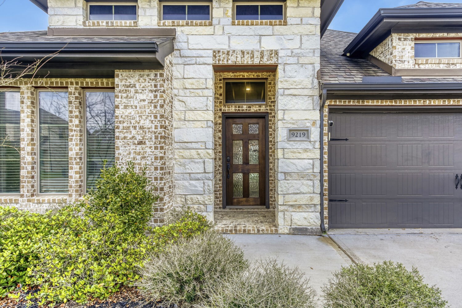 9219 Eckert Road Iowa Colony, TX 77583 - Photo 4 of 26 The gorgeous stone and brick combination along with the modern, freshly-refinished front door makws for a welcoming walk up.