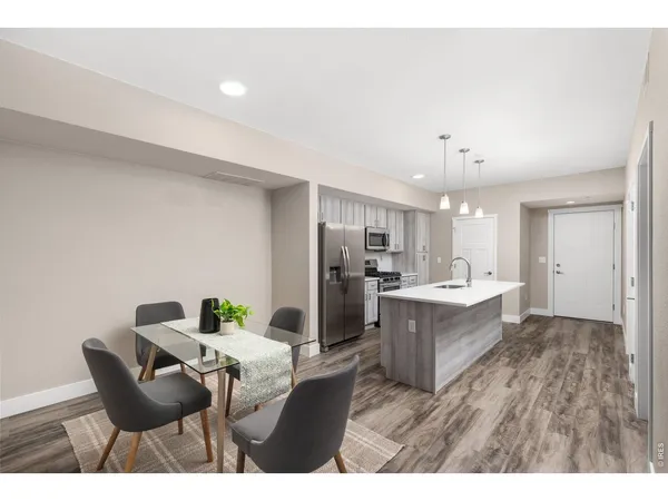 a living room with kitchen island furniture and a kitchen view