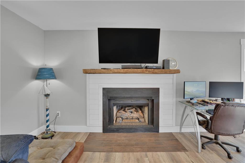 231 Cardinal Point Monticello, GA 31064 - Photo 22 of 40 a living room with furniture a fireplace and a flat screen tv