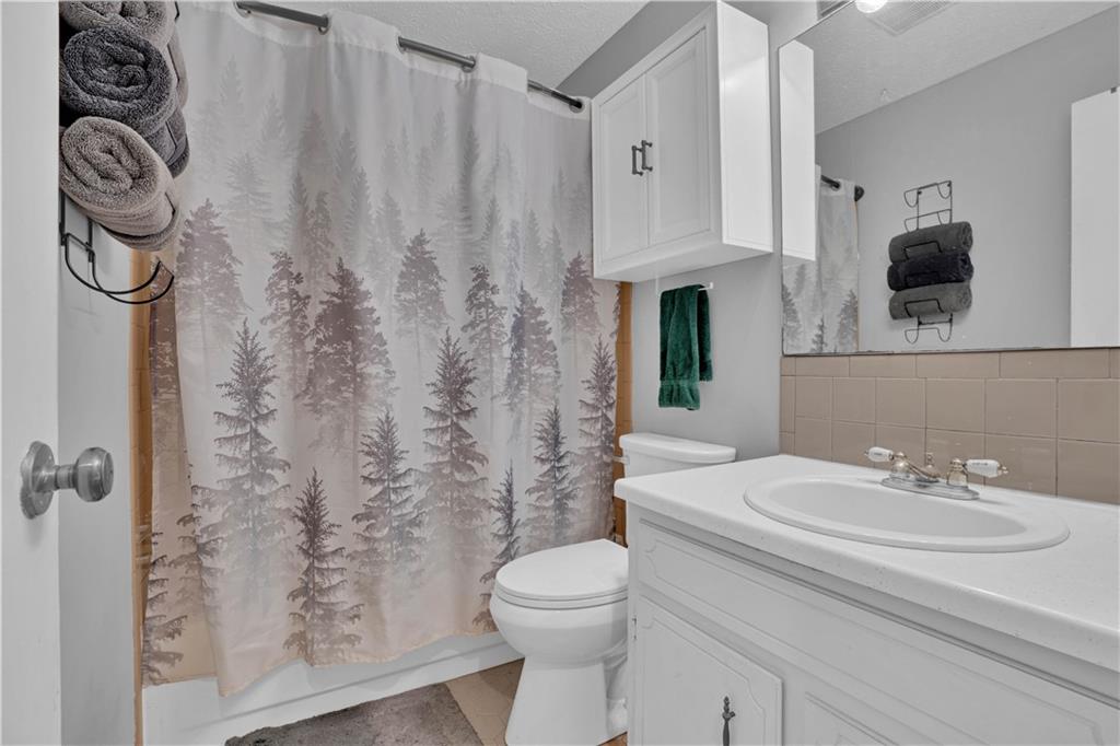 231 Cardinal Point Monticello, GA 31064 - Photo 32 of 40 a bathroom with a sink a toilet and shower curtain