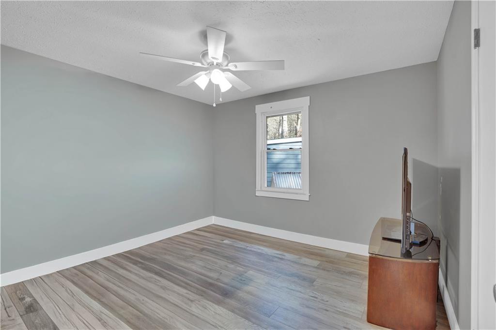231 Cardinal Point Monticello, GA 31064 - Photo 35 of 40 wooden floor in an empty room with a window