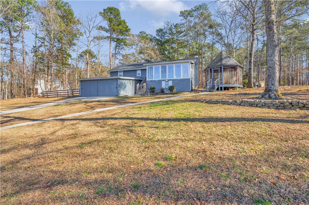 231 Cardinal Point Monticello, GA 31064 - Photo 9 of 40 a view of a house with a yard and tree s