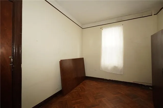 a view of a room with wooden floor and windows