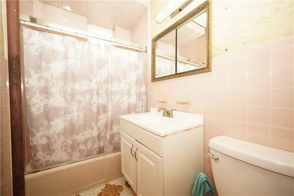 1636 Dahill Road Brooklyn, NY 11223 - Photo 12 of 19 a bathroom with a sink a toilet and a mirror