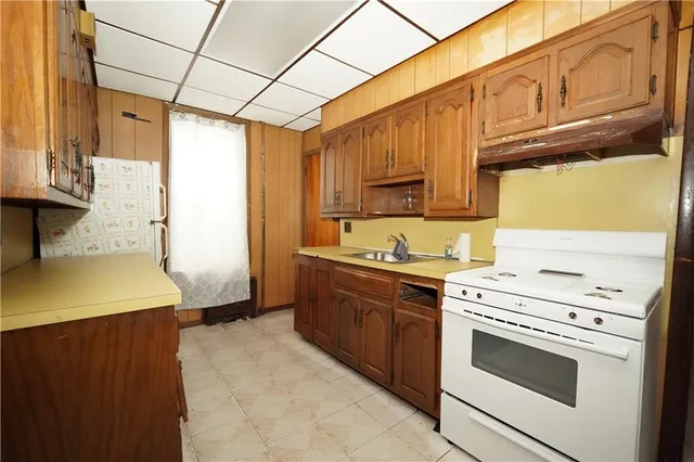 a kitchen with granite countertop cabinets stainless steel appliances and a counter space