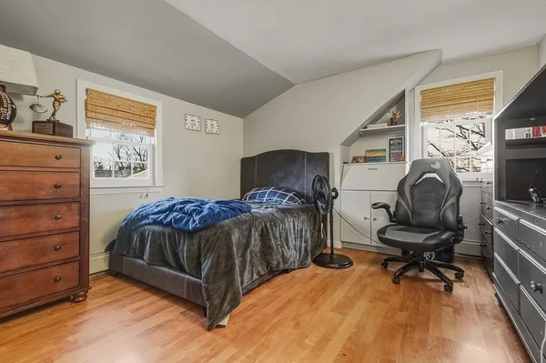 a bedroom with a bed and chair