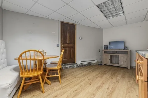 a view of a kitchen with furniture wooden floor and window