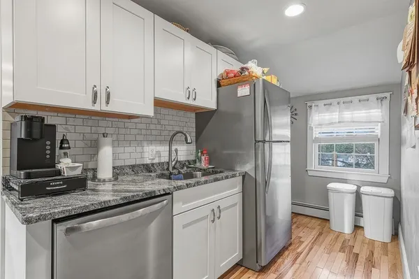 a kitchen with stainless steel appliances granite countertop a refrigerator sink and cabinets