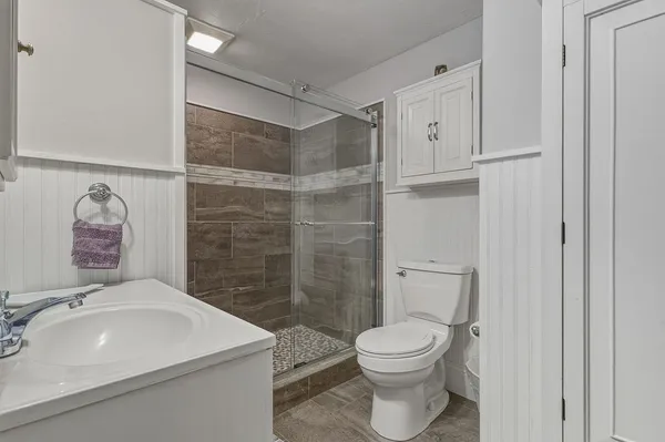 a bathroom with a sink toilet and shower