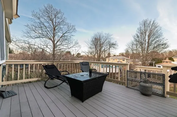 a view of house with deck and outdoor seating