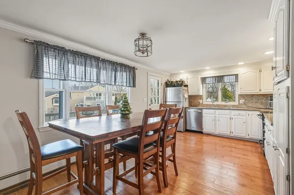 a view of a dining room with furniture and wooden floor