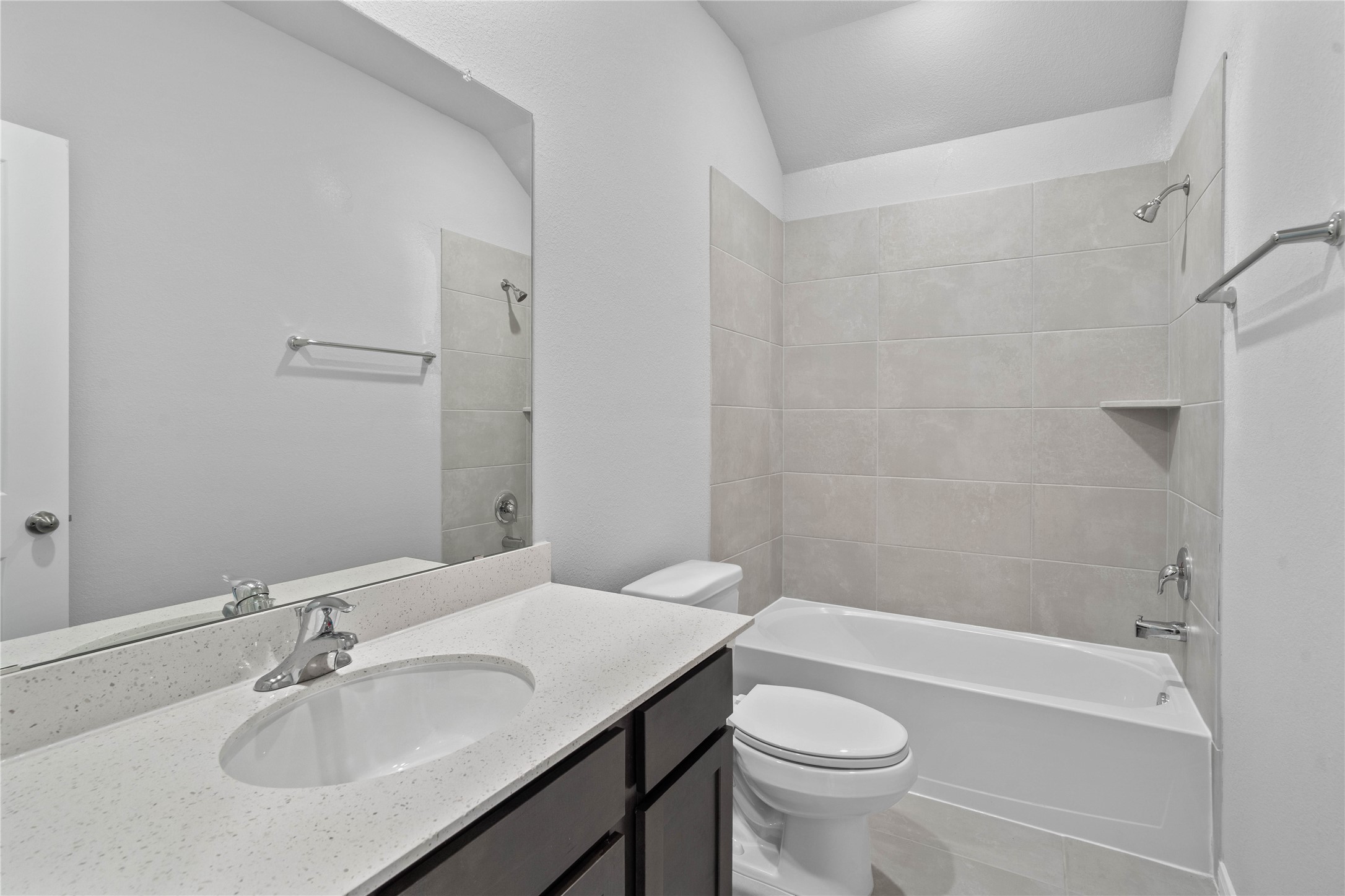 19555 Montgomery Rdg Way Montgomery, TX 77316 - Photo 11 of 38 A streamlined secondary bathroom providing a functional tub/shower combination and modern fixtures, seamlessly blending practicality and style.