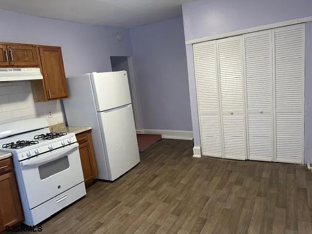 a white refrigerator freezer sitting inside of a kitchen