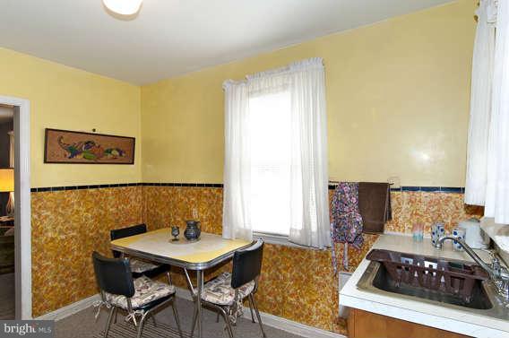 4523 Maple Road Morningside, MD 20746 - Photo 11 of 19 a living room with a table and a stove