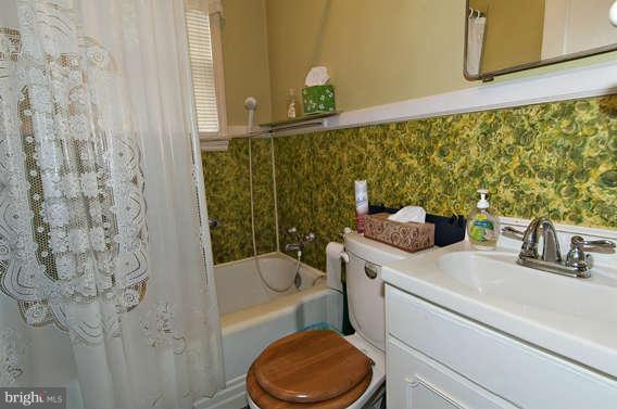 4523 Maple Road Morningside, MD 20746 - Photo 12 of 19 a bathroom with a sink toilet and shower