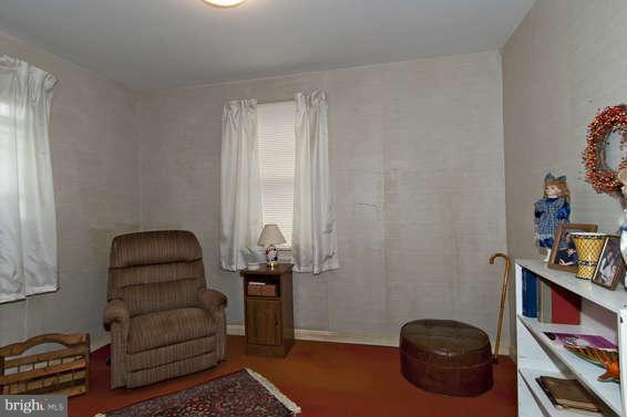 4523 Maple Road Morningside, MD 20746 - Photo 14 of 19 a room with furniture and a book shelf