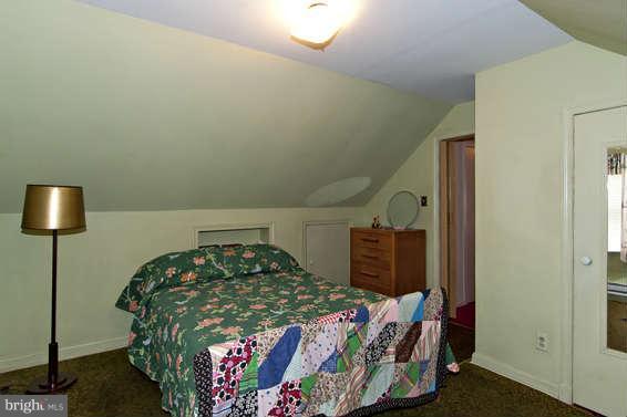 4523 Maple Road Morningside, MD 20746 - Photo 17 of 19 a bedroom with a bed and a lamp