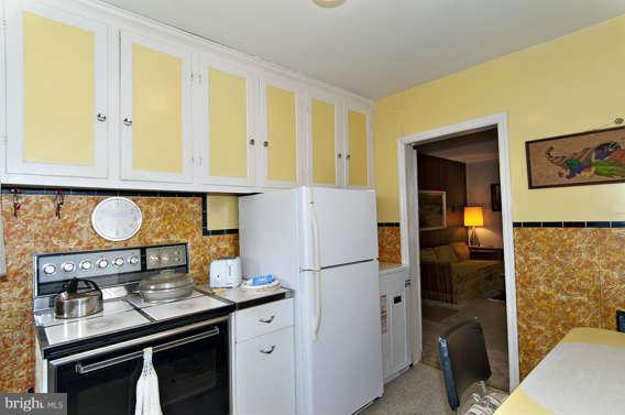 4523 Maple Road Morningside, MD 20746 - Photo 10 of 19 a kitchen with stainless steel appliances granite countertop a stove and a refrigerator