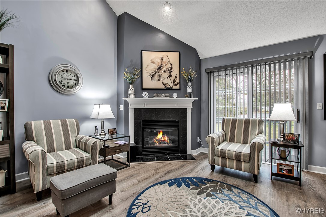 2850 Amsdell Road, Unit 1 Hamburg, NY 14075 - Photo 6 of 50 Liv Rm w/gas fireplace, vaulted ceiing + slding dr