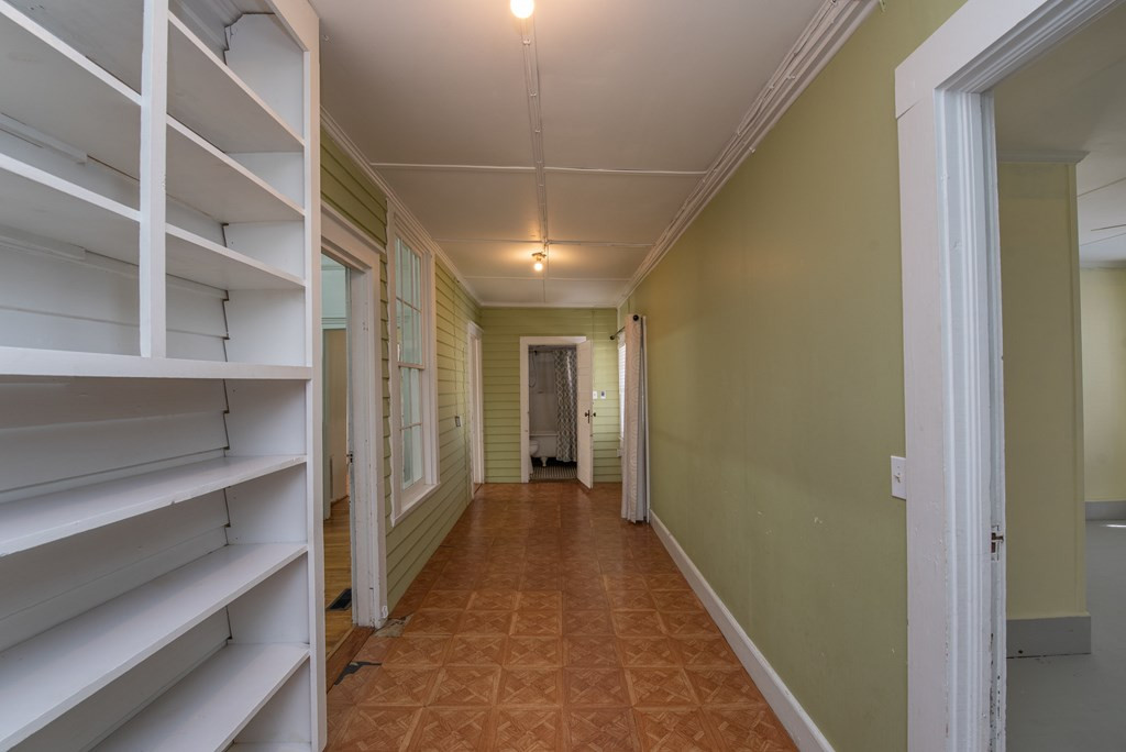 204 Green Street Ridge Spring, SC 29129 - Photo 29 of 40 Long hallway with bookshelves