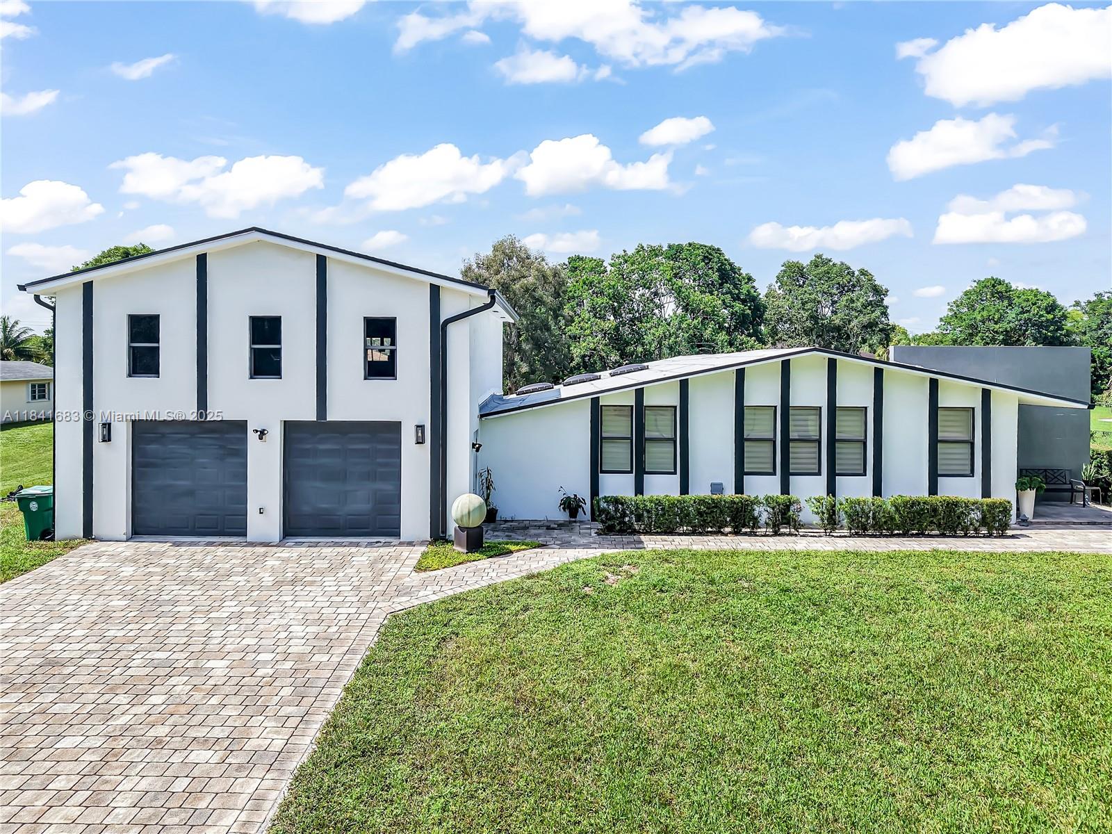 17101 Southwest 48th Street Southwest Ranches, FL 33331 - Photo 1 of 40 a front view of house with yard and green space