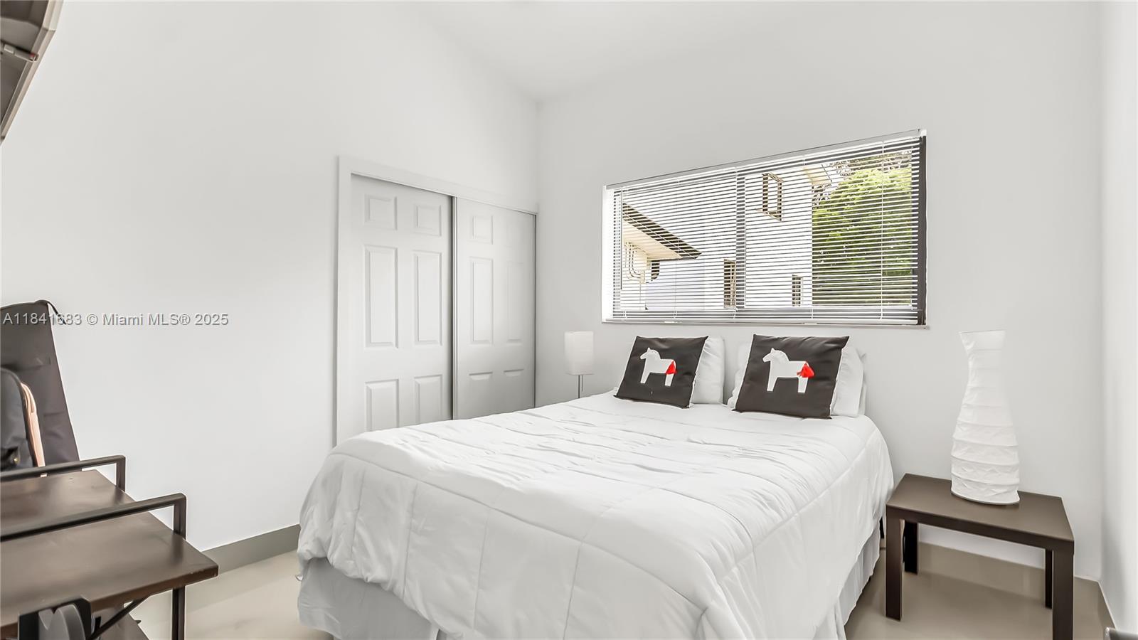 17101 Southwest 48th Street Southwest Ranches, FL 33331 - Photo 11 of 40 a bedroom with a bed and a window