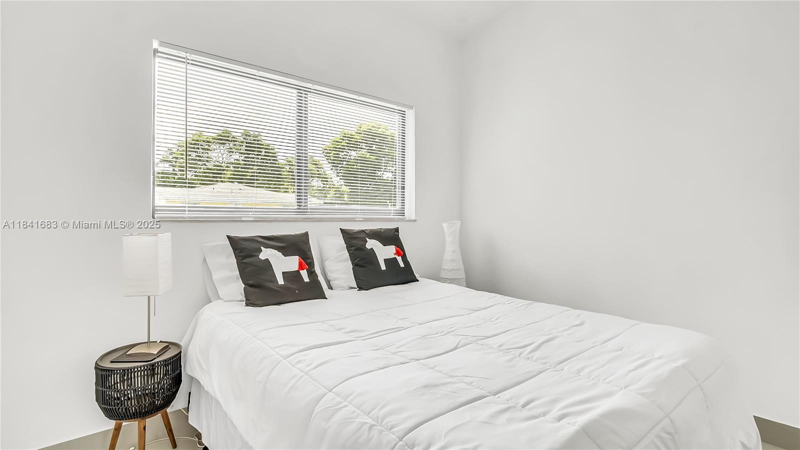 17101 Southwest 48th Street Southwest Ranches, FL 33331 - Photo 12 of 40 a bedroom with a bed and a window