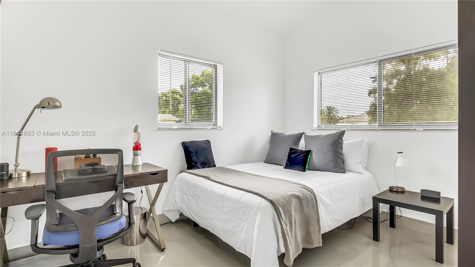 17101 Southwest 48th Street Southwest Ranches, FL 33331 - Photo 13 of 40 a bedroom with a bed a large window and chair