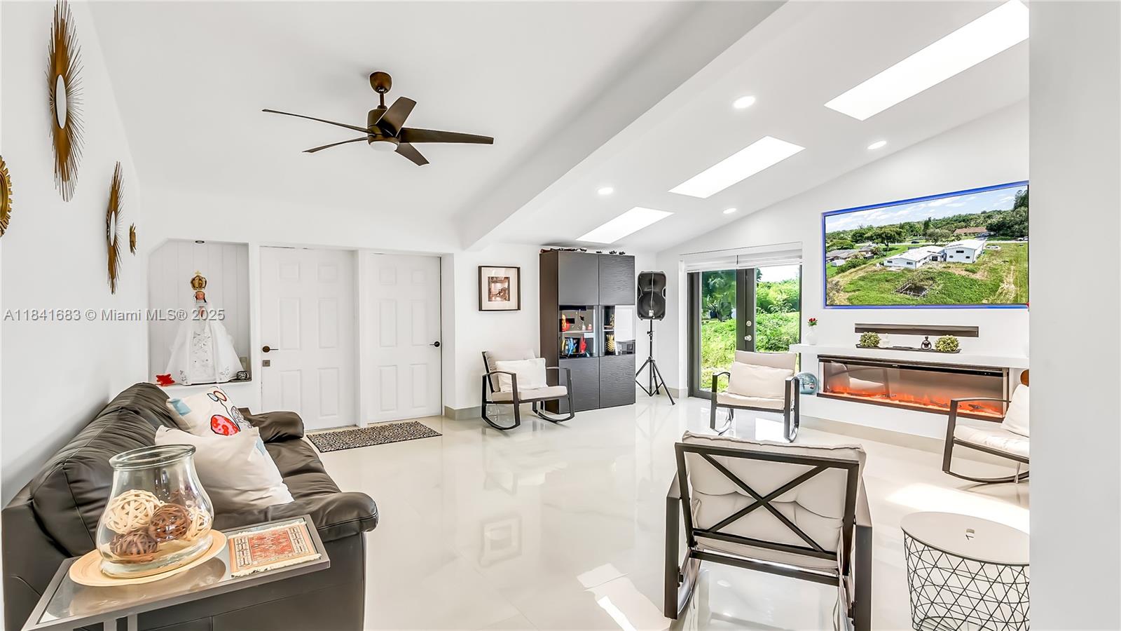 17101 Southwest 48th Street Southwest Ranches, FL 33331 - Photo 16 of 40 a living room with furniture and a flat screen tv