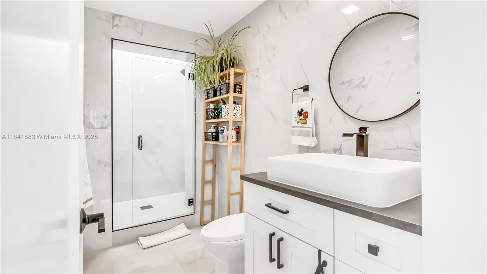 17101 Southwest 48th Street Southwest Ranches, FL 33331 - Photo 17 of 40 a bathroom with a sink a toilet and shower