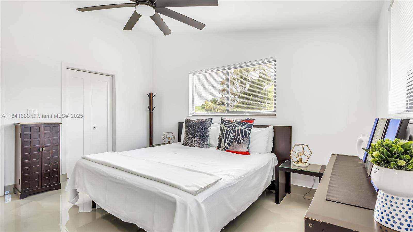 17101 Southwest 48th Street Southwest Ranches, FL 33331 - Photo 21 of 40 a bedroom with a bed and a potted plant