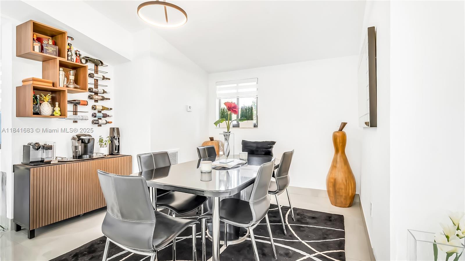 17101 Southwest 48th Street Southwest Ranches, FL 33331 - Photo 28 of 40 a dining room with furniture and wooden floor