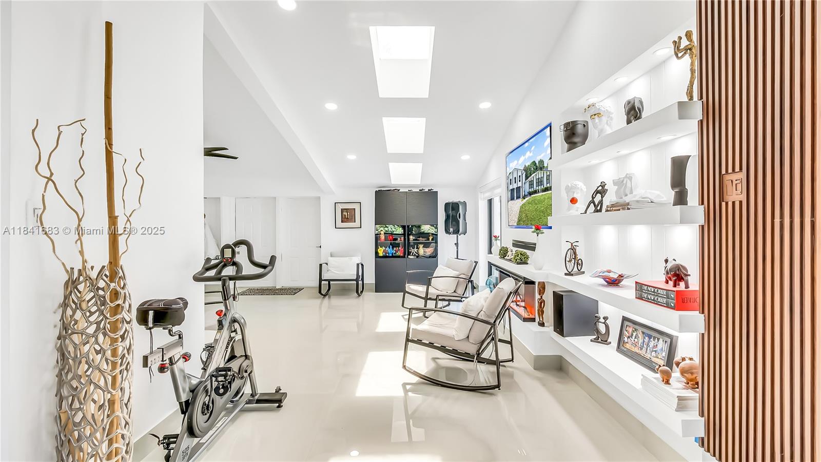 17101 Southwest 48th Street Southwest Ranches, FL 33331 - Photo 30 of 40 a living room with furniture and a book shelf